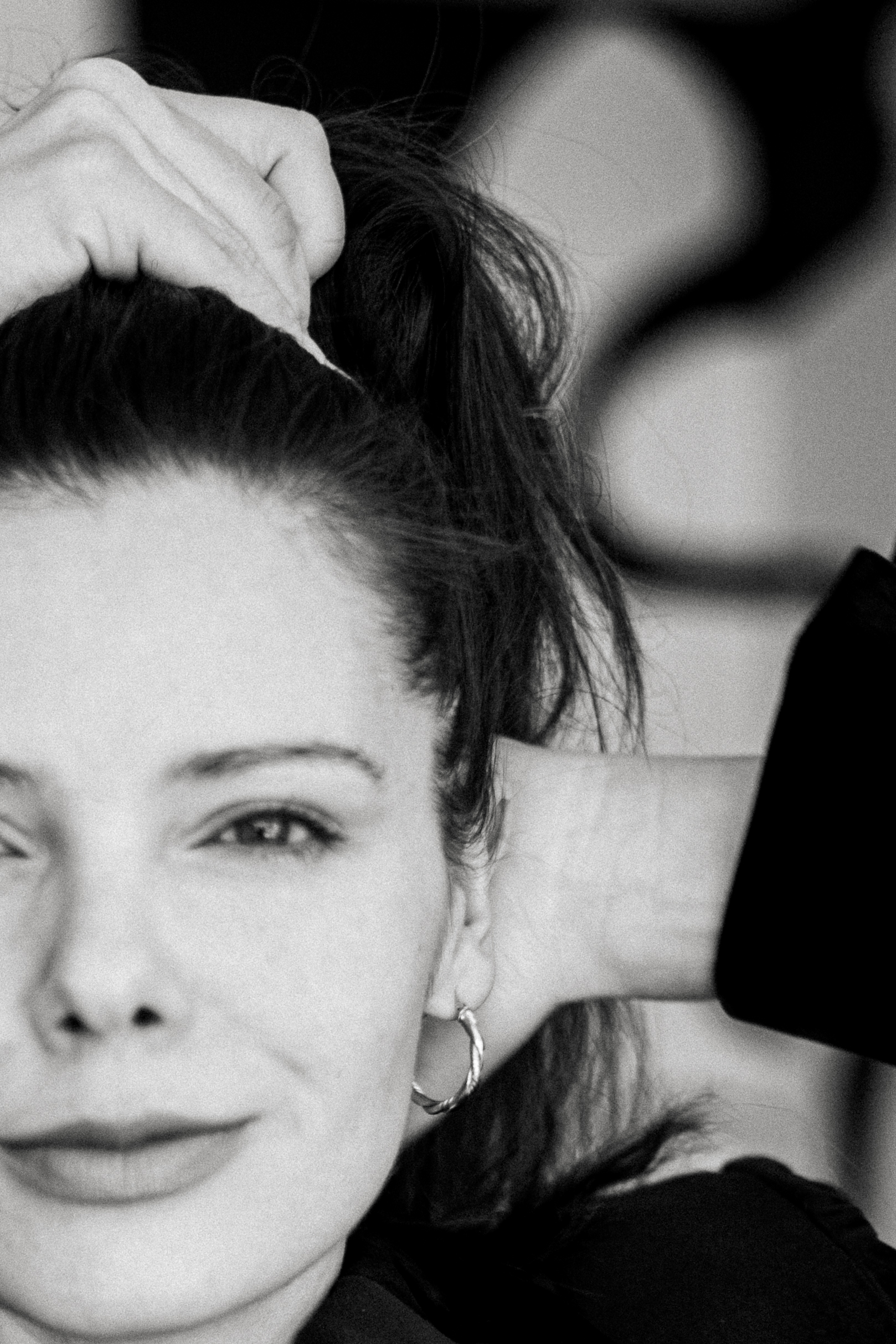 Black-and-white portrait of Edyta Maksimowicz holding her hair