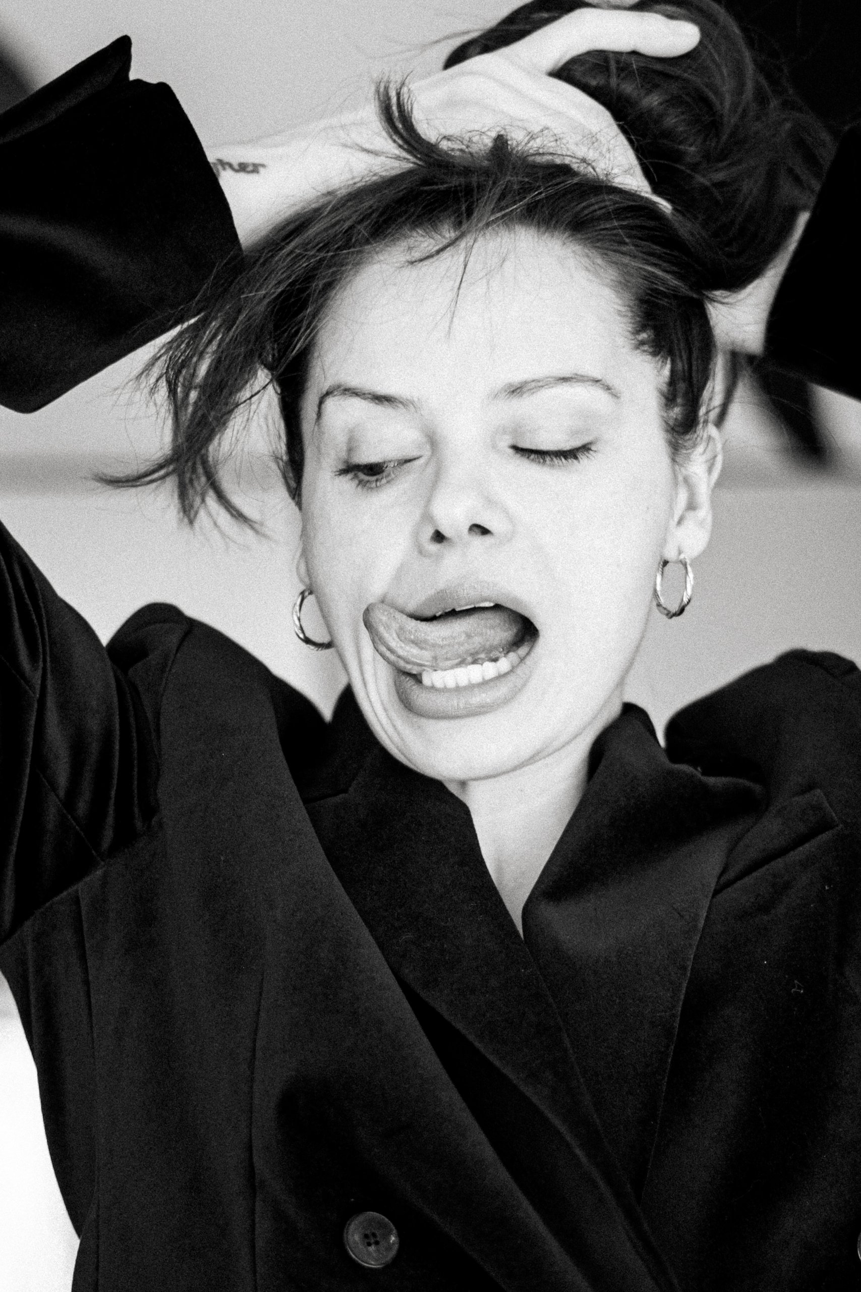 Edyta Maksimowicz with her hands in her hair and tongue out